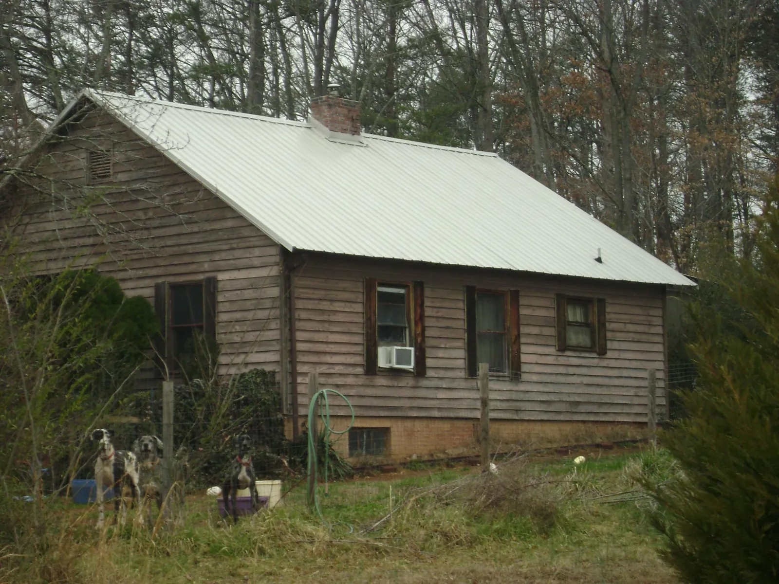 White metal roof on an old wood sided farmhouse, from a Metal Roof Installation job in Ruther Glen
